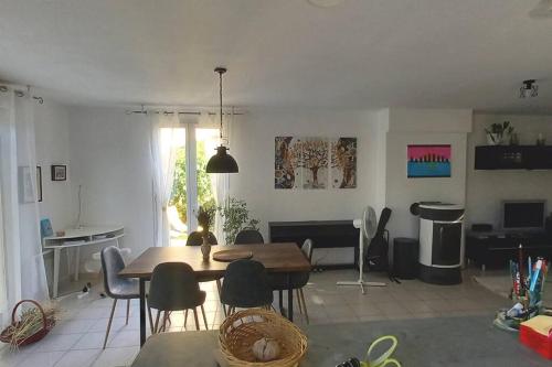 sala de estar con mesa de comedor y sillas en House of magic lake, en Gréoux-les-Bains