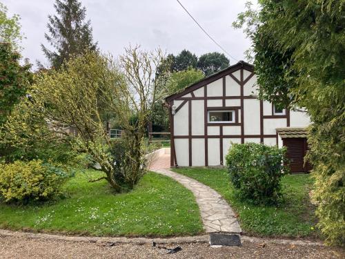 a black and white house with a walkway in front at Gîte de Blay in Blay