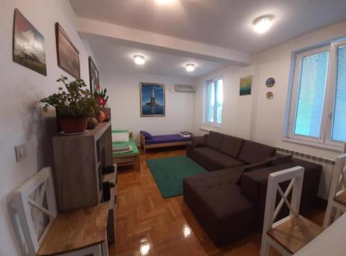 a living room with a couch and a table at TPC 9 in Žarkovo