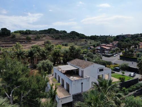 an aerial view of a white house in a village at PetraSicula Apartment in Acitrezza