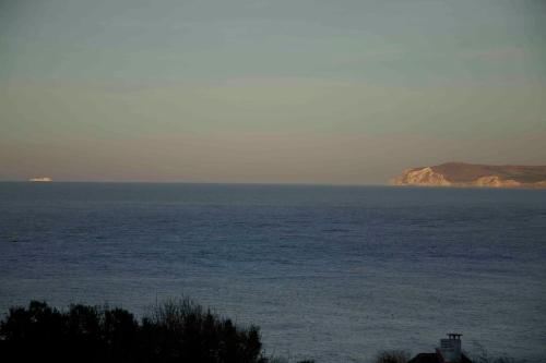a large body of water with an island in the distance at Villa vue exceptionnelle sur le Cap Gris-Nez in Audinghen