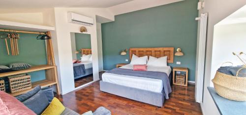 a bedroom with a bed and a couch at PetraSicula Apartment in Acitrezza