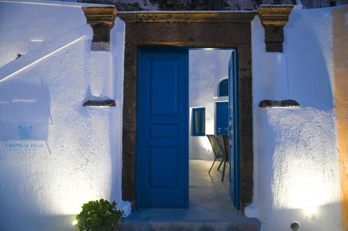 a blue door on the side of a white building at Mary Castelia Villa with Jacuzzi in Akrotiri