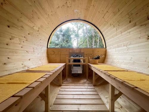 an inside view of a wooden cabin with a window at Kurasako Onsen Sakura in Minamioguni