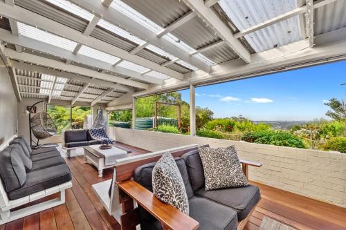 a living room with a couch and chairs at Lush rural retreat in Korumburra