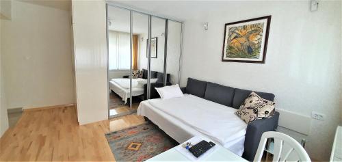 a living room with a bed and a couch at Apartment Osijek-Tvrda in Osijek