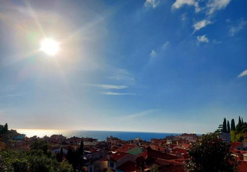 una vista de una ciudad con el sol en el cielo en Apartment Sulle scale en Piran