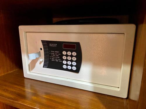 a microwave oven sitting on top of a wooden table at The Royal Hotel by Coastlands Hotels & Resorts in Durban