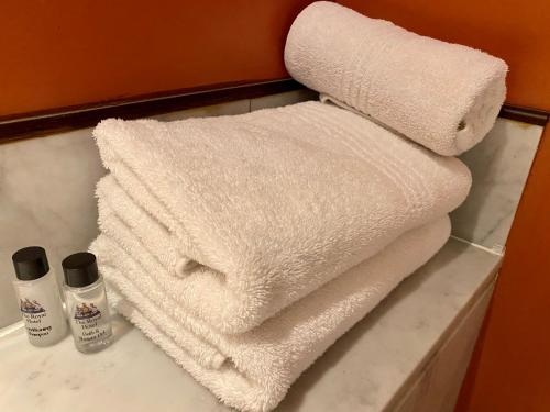 a pile of towels on a counter in a bathroom at The Royal Hotel by Coastlands Hotels & Resorts in Durban
