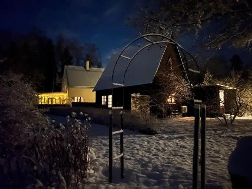 a house in the snow at night with a street light at Längtan Marielund in Uppsala