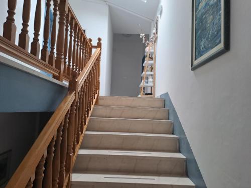 a staircase in a home with wooden railings at Sobe MaMaLu in Valun