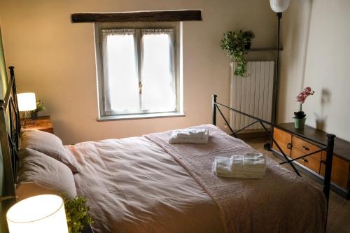a bedroom with a bed with two towels on it at Elio's secret spot in Crema