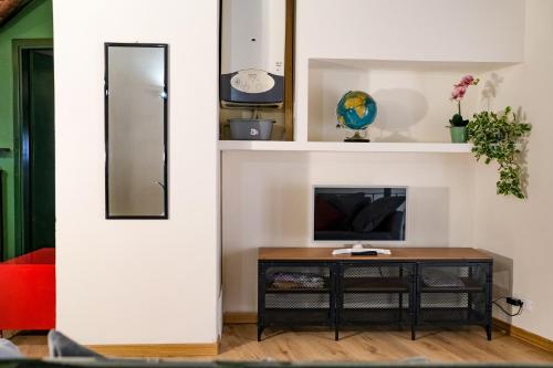 a living room with a table and a mirror at Elio's secret spot in Crema
