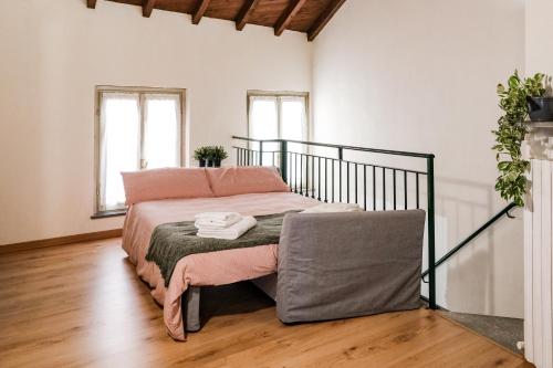 a bedroom with a bed with pink sheets at Elio's secret spot in Crema