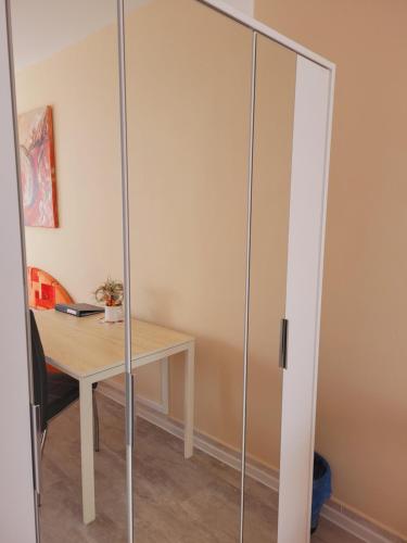 a glass partition in a room with a desk at Apartmány Brno in Brno