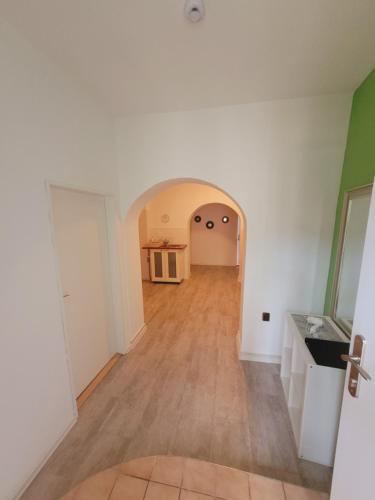 an empty room with a wooden floor and white walls at Apartmány Brno in Brno