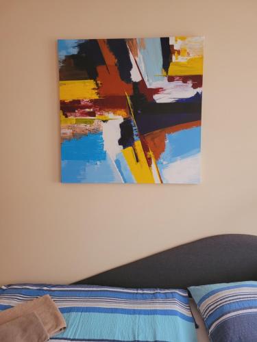 a painting hanging on a wall above a bed at Apartmány Brno in Brno