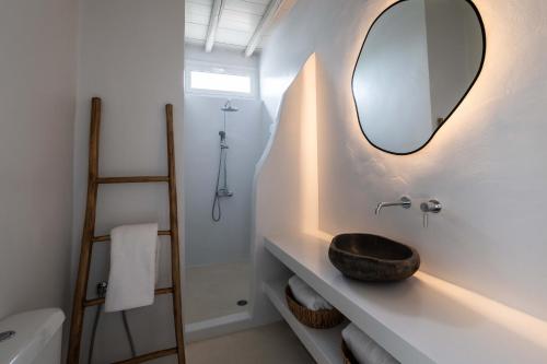 a bathroom with a sink and a mirror at Cavos Paros Boho Chic sea-view apartment in Aliki in Aliki