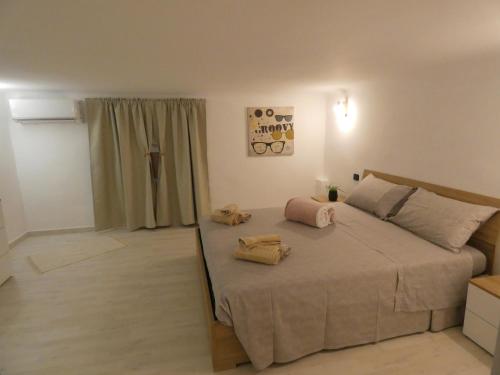 a bedroom with a large bed with two pillows on it at CASA SIMONETTA in Bari