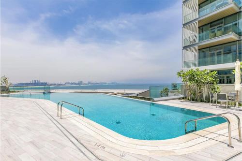 a swimming pool on the side of a building at Livbnb - Alluring 3BR+1 w/Sea & Ain Dubai View in Dubai