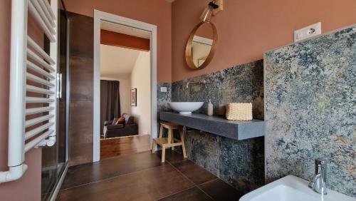 a bathroom with a sink and a mirror at PetraSicula Apartment in Acitrezza