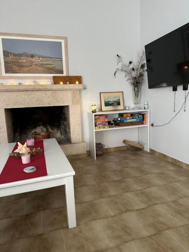 a living room with a fireplace and a tv at Lena's Home in Aegina Town
