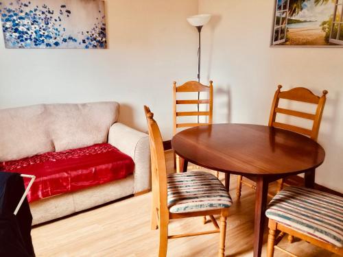 a living room with a table and a couch at Inverken House in Inshes