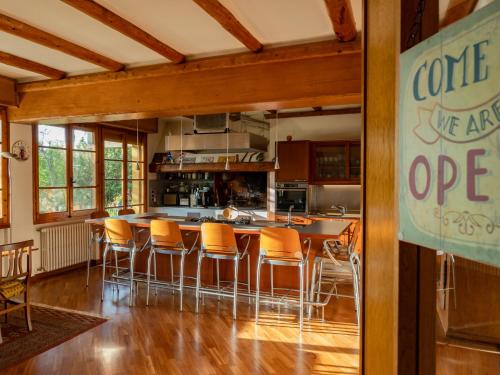 a kitchen with a bar with orange chairs at B&B Casa Decimo in Greve in Chianti