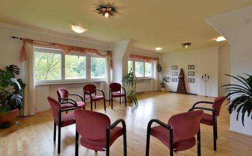 a room with chairs and a table and windows at Biolandhaus Seethaler in Vorderthiersee
