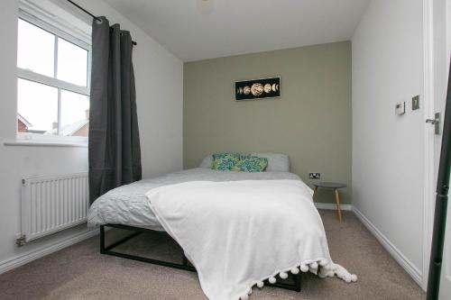 a bedroom with a bed and a window at Cozy House in The Heart of Colchester in Colchester