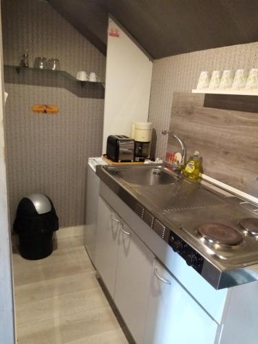 a kitchen with a sink and a counter top at Havre de paix au bords de l'Eure - divers hébergements in Neuilly