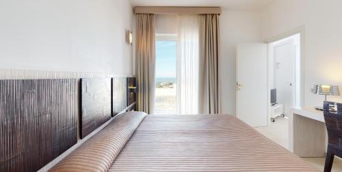 Ένα ή περισσότερα κρεβάτια σε δωμάτιο στο Monte Sarago Villas