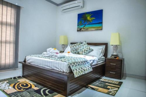 a bedroom with a bed and a nightstand and a bed sidx sidx sidx sidx at Island Charm of Praslin in Victoria