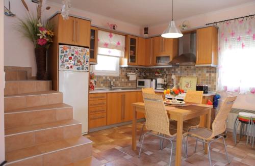 una cucina con tavolo e frigorifero di House of the Sun a Kavala
