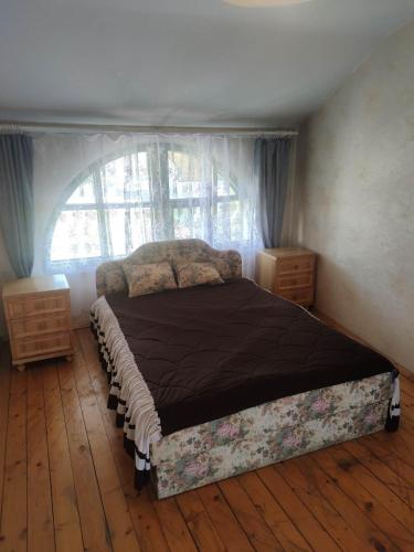a bedroom with a large bed with a window at Tilžė in Šiauliai