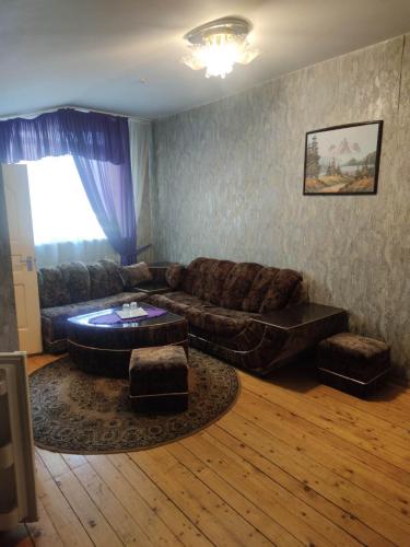 a living room with a couch and a table at Tilžė in Šiauliai