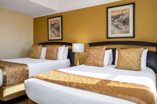 a hotel room with two beds in a room at Gilmore Hotel, Trademark Collection by Wyndham in Ketchikan