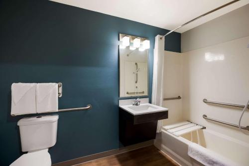 a bathroom with a white toilet and a sink at WoodSpring Suites Orlando West - Clermont in Clermont