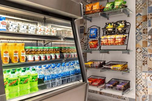 a refrigerator filled with lots of soda and drinks at Hyatt Centric Santa Clara Silicon Valley in Santa Clara