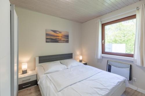 SimonsbergにあるWattenmeerのベッドルーム(大きな白いベッド1台、窓付)