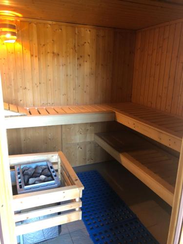 a sauna with wooden walls and a wooden shelfitures at Hotel Ötscherblick in Lackenhof
