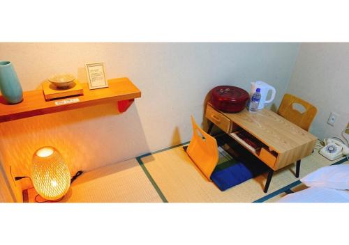 Zimmer mit einem Tisch, einem Bett, einem Tisch und einem Stuhl in der Unterkunft Nara Ryokan - Vacation STAY 49528v in Nara