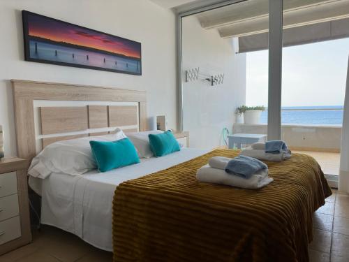 a bedroom with a large bed with a television on the wall at Calatabarca B&B in Tabarca