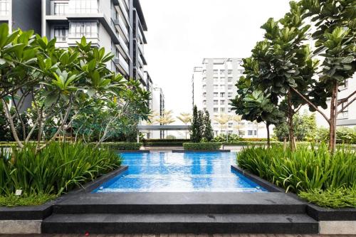 a swimming pool in the middle of a building at BOHO Geniehome 3BR free W-ifi @ Utropolis ShahAlam in Shah Alam