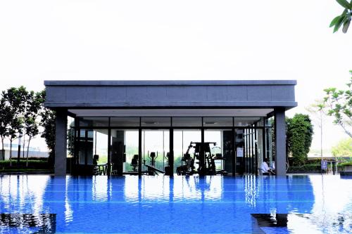 a building with blue water in front of it at BOHO Geniehome 3BR free W-ifi @ Utropolis ShahAlam in Shah Alam