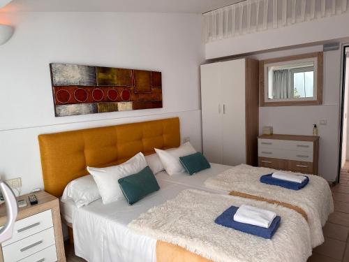a bedroom with two beds with towels on them at Calatabarca B&B in Tabarca