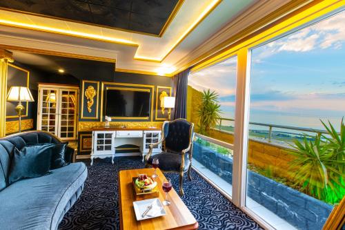 a living room with a view of the ocean at Andalouse Elegant Suite Hotel in Trabzon