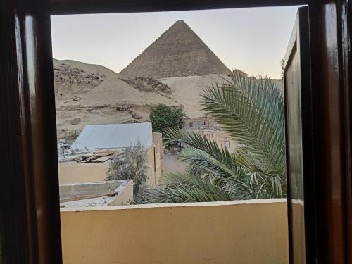 a view of the pyramids from a window of a building at Crystal pyramid inn in Cairo