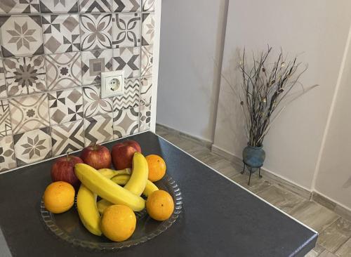 a bowl of fruit on a table in a kitchen at Apartment Belle Epoque in Lixouri