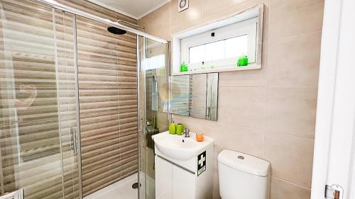 a bathroom with a toilet and a sink and a shower at Casa da Quinta by Sunny Deluxe in Cabeção